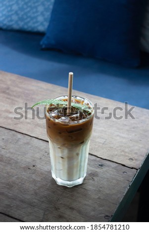 Coffee glass decorated with fern leaf, stock photo