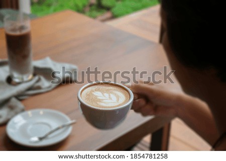 Hot coffee on hand of woman, stock photo