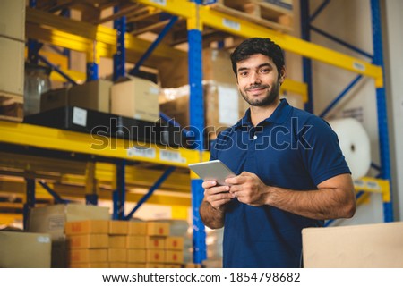Male warehouse worker portrait in warehouse storage Royalty-Free Stock Photo #1854798682