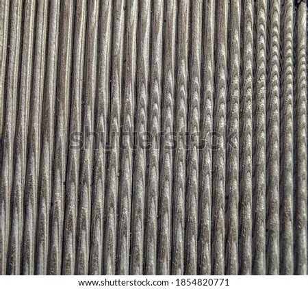 unusual radial pattern on a wooden old ribbed board photographed close-up. wood abstract background