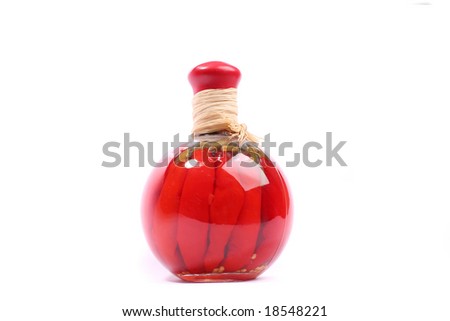 A jar of red peppers over white background