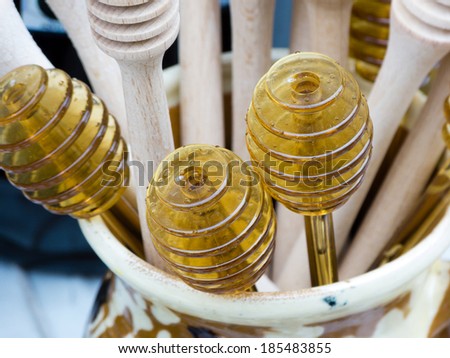 Wooden spoons for honey  in a ceramic pot