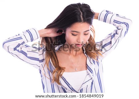 young Asian  woman fixing her hair. isolated on white background