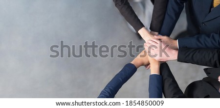 Top view, Cropped view of A group of Business people putting their hands together, Friends with stack of hands showing unity, Teamwork, Success and Unity concept Royalty-Free Stock Photo #1854850009