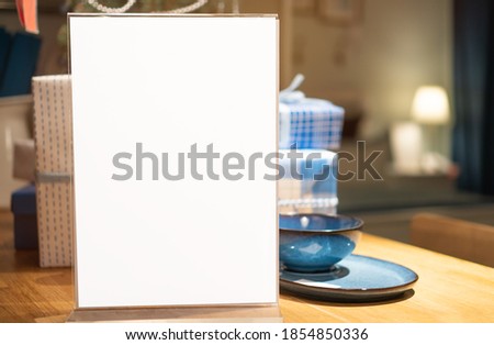 White mockup acrylic frame posters pattern template forms background on table for letter sheet ready to use display your product, blurred background insert for text of customer. Space for texting