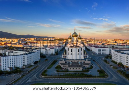 Picturesque morning cityscape. Aerial view of the city of Magadan. View of the large cathedral, streets and buildings at sunrise. Holy Trinity Cathedral, Magadan, Magadan Region, Far East of Russia. Royalty-Free Stock Photo #1854865579