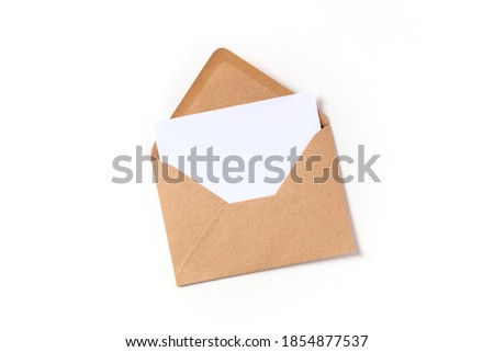 Greeting card in a brown kraft envelope mockup, shot from above on a white background with a place for text Royalty-Free Stock Photo #1854877537