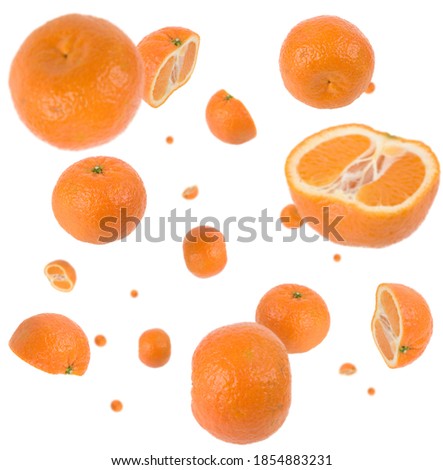 Many clementines freefalling in mid air on white background. Selective focus - shallow depth of field.