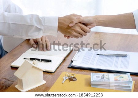 Sale representative or insurance broker handshake with customer after house purchase contract buy a house or apartment 