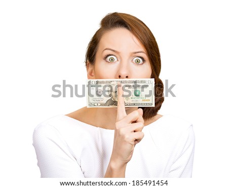 Closeup portrait young corrupt woman, white dress with twenty dollar bill taped to mouth, showing shhh sign, isolated white background, clipping path. Bribery concept in politics, business, diplomacy.