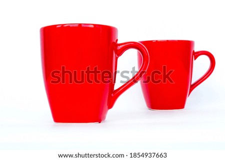 Red mug. Two red cups isolated on a white background.