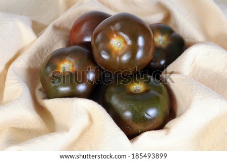 a group of brown tomatoes on napkin 