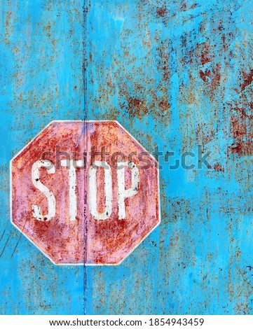 Stop letters on the wall of the fence