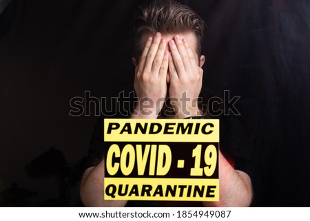 Coronavirus, quarantine, covid-19 and pandemic concept. Sad and sick man of corona virus looking through the window.