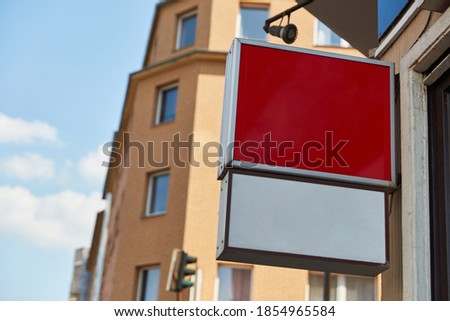 Blank sign as a mock-up template for logo or company name on a building in the city