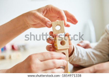 Seniors stacking building blocks as therapy or games in the retirement home Royalty-Free Stock Photo #1854971338