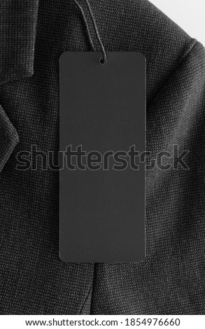 Black tag mockup on a black suit.