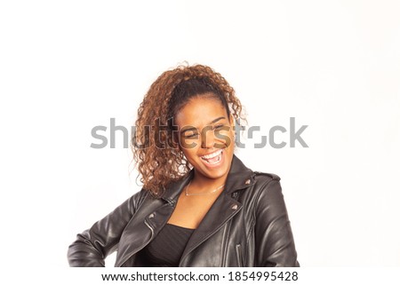 Portrait of pretty young hispanic woman with curly hair posing for  the camera on isolated background.