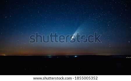 Wonderful view of starry sky and C/2020 F3 (NEOWISE) comet with light tail. Location place of Ukraine, Europe. Long exposure shot, astrophotography. Dramatic wallpaper. Discover the beauty of earth.