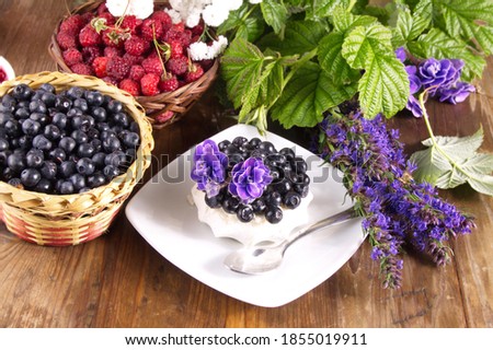 Cream cake with fresh raspberries and blueberries sweet dessert