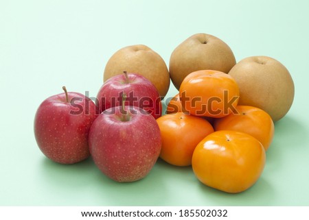 Variety of fruit on green background 