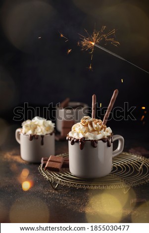 A cap of hot chocolate with whipped cream and cinnamon, selective focus image