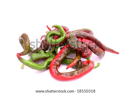 Ripe and unripe peppers over white background