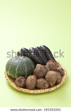 Pumpkin, eggplant and taro on green background 
