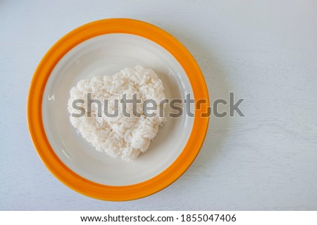 Heart shaped rice in a plate on a white background