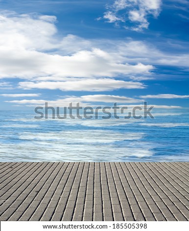 concrete pier on the sea and sky with clouds