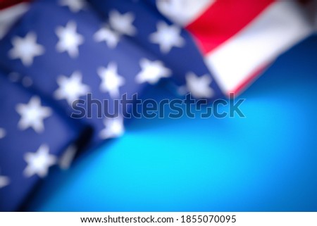Blurred American flag in daylight on a blue background, banner for design