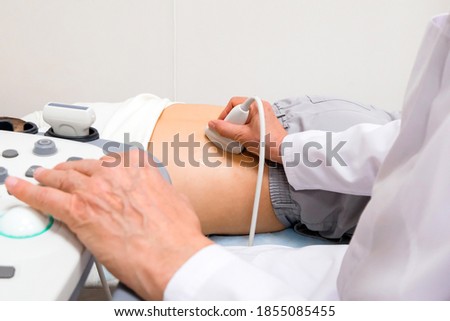 Examination of the kidneys with an ultrasound scanner. Urologist Royalty-Free Stock Photo #1855085455