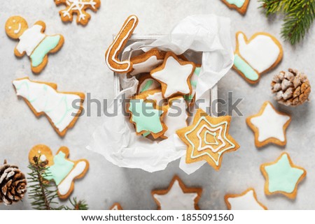Christmas cookies decorated with iced colored sugar on the light background. Pattern concept