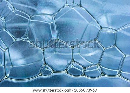 Abstract rectangular shaped soap bubbles in plastic bottle macro close up front view.