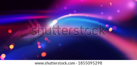 The stream of energy emanating from female hands close-up on a dark abstract background. Neon glow, bokeh, magic particles Royalty-Free Stock Photo #1855095298
