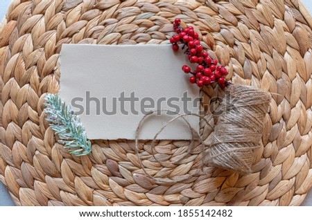 
Christmas concept. Blank yellow message card Pine tree branch red berries and jute rope. Flat lay top view