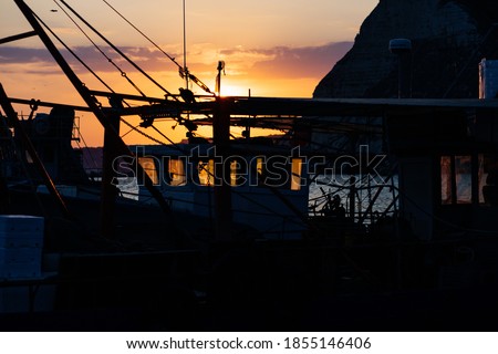 Sunset with a view through a fishing trawler lying in the port of Kavarna, Bulgaria