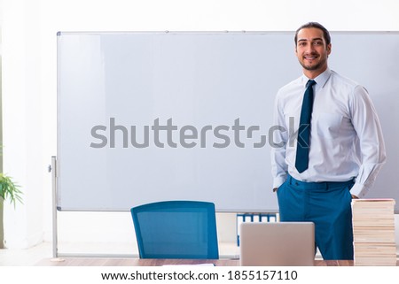 Young male employee in business presentation concept