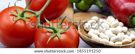 vegetables and haricot beans on a wooden board