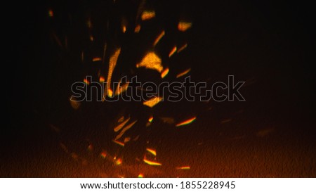 bunch of small light glare on a dark background, sparks, blurred picture