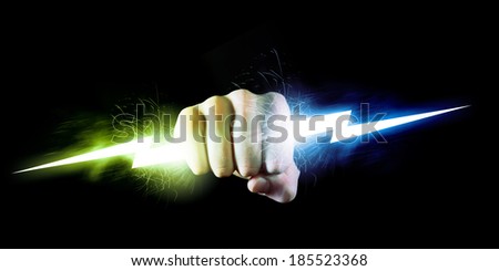 Businessman holding lightning in fist. Power and control Royalty-Free Stock Photo #185523368