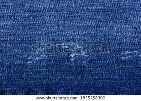 Closeup of denim jeans textile texture background.