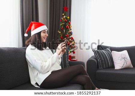 Woman buying Christmas gifts online
