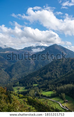 Aerial View alp mountains In South Tyrol region in Italy with a road in the valley.