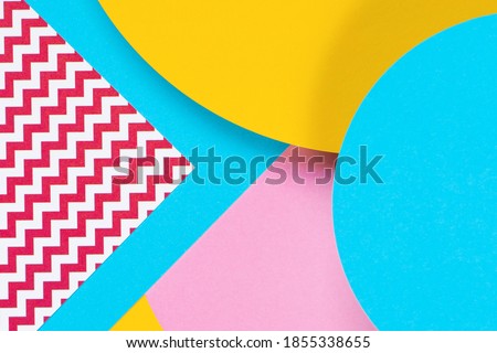Abstract geometric fashion papers texture background in yellow, light pink, blue colors. Top view, flat lay