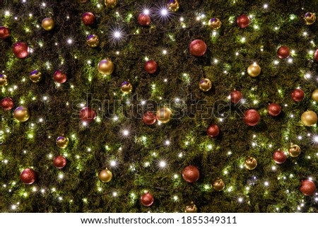 Christmas tree festive background decoration view with balls and garland lamps light and sparkles in evening time 
