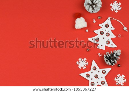 Red background with white Christmas tree, stars, hat and cones. Christmas.