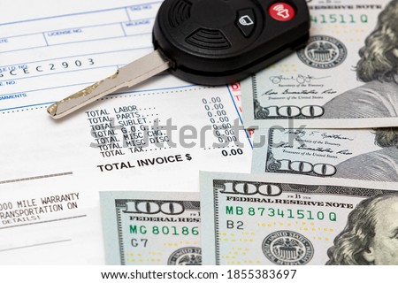 Car key, vehicle warranty repair bill and 100 dollar bills cash. Concept of vehicle manufacturer extended warranty. Automobile maintenance and service costs Royalty-Free Stock Photo #1855383697