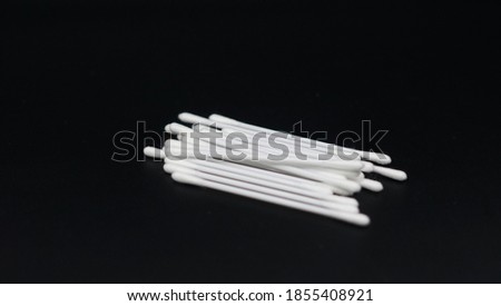 image of cotton buds on black background