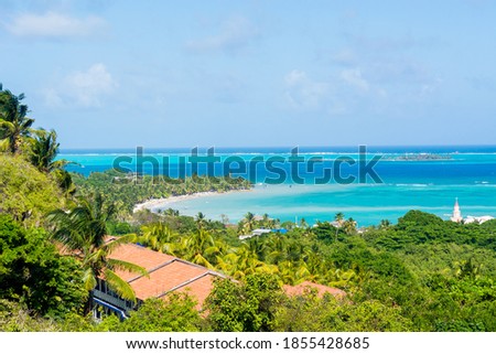 Landscape of the beach of San Andres island and Providencia Archipelago in Colombia with blue ocean and green palms and vegetation with boats and tourists   Royalty-Free Stock Photo #1855428685
